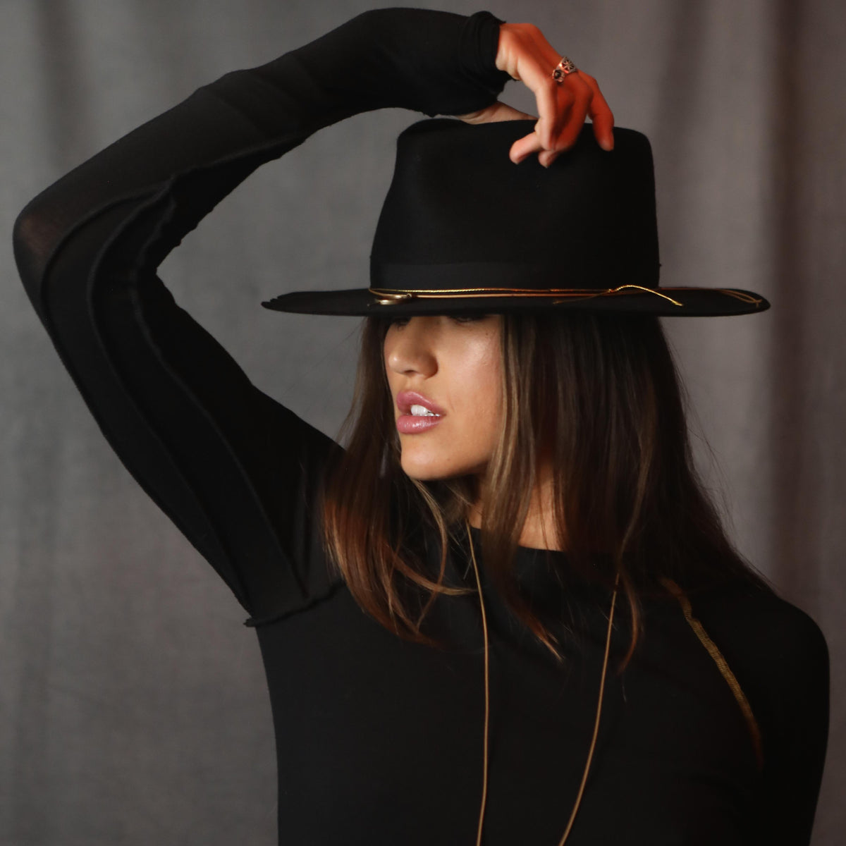 A woman modeling the One Golden Thread Reversible Little Black Dress