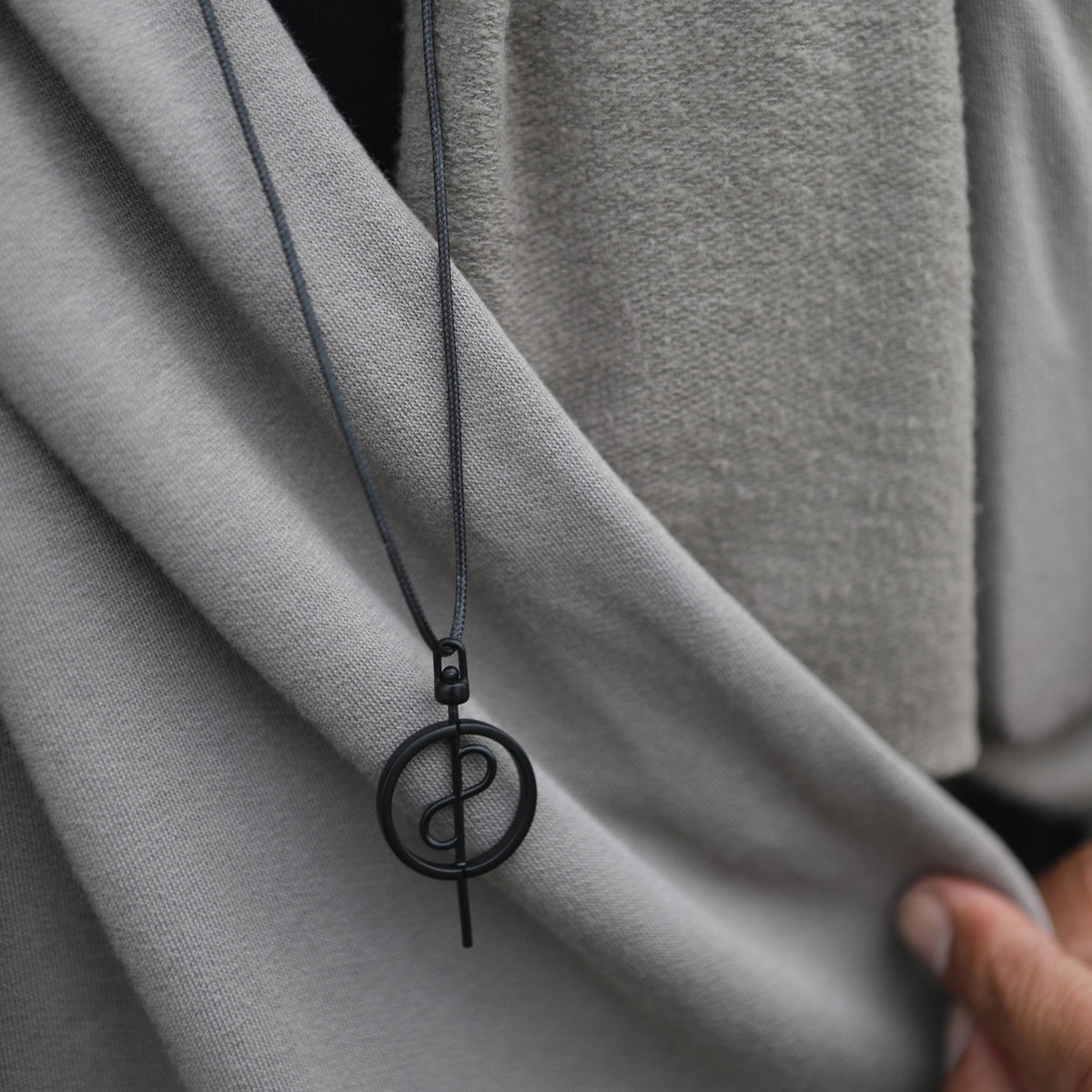 Male modeling grey fleece scarf