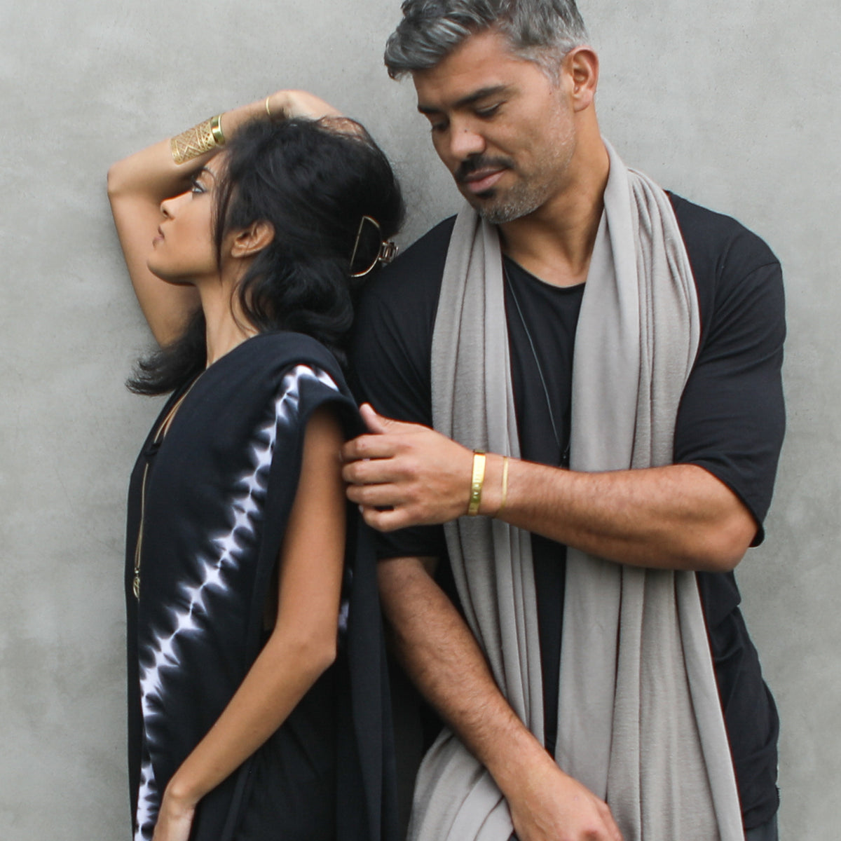 Two models modeling fleece scarves