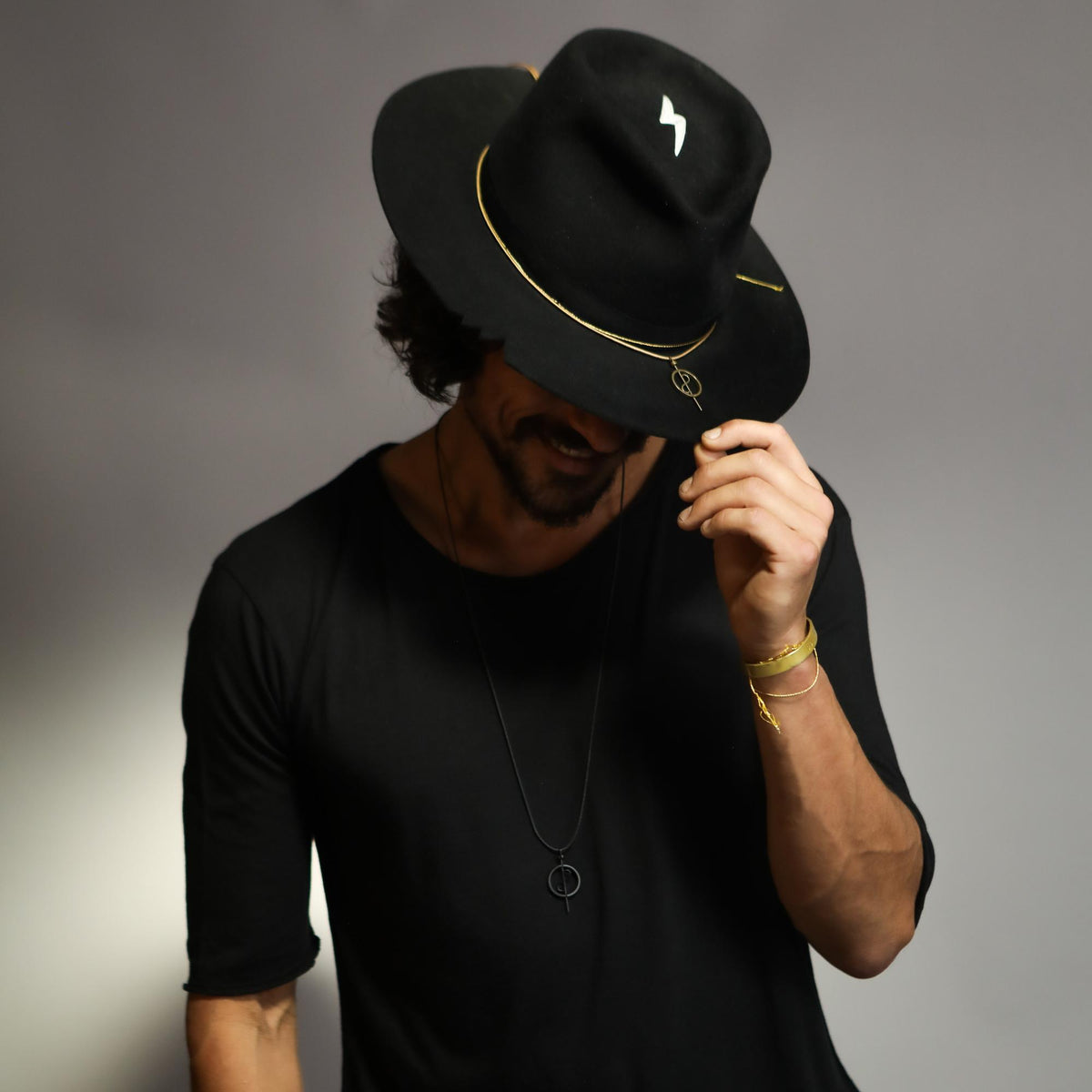 Male modeling bespoke hat and 108 talisman