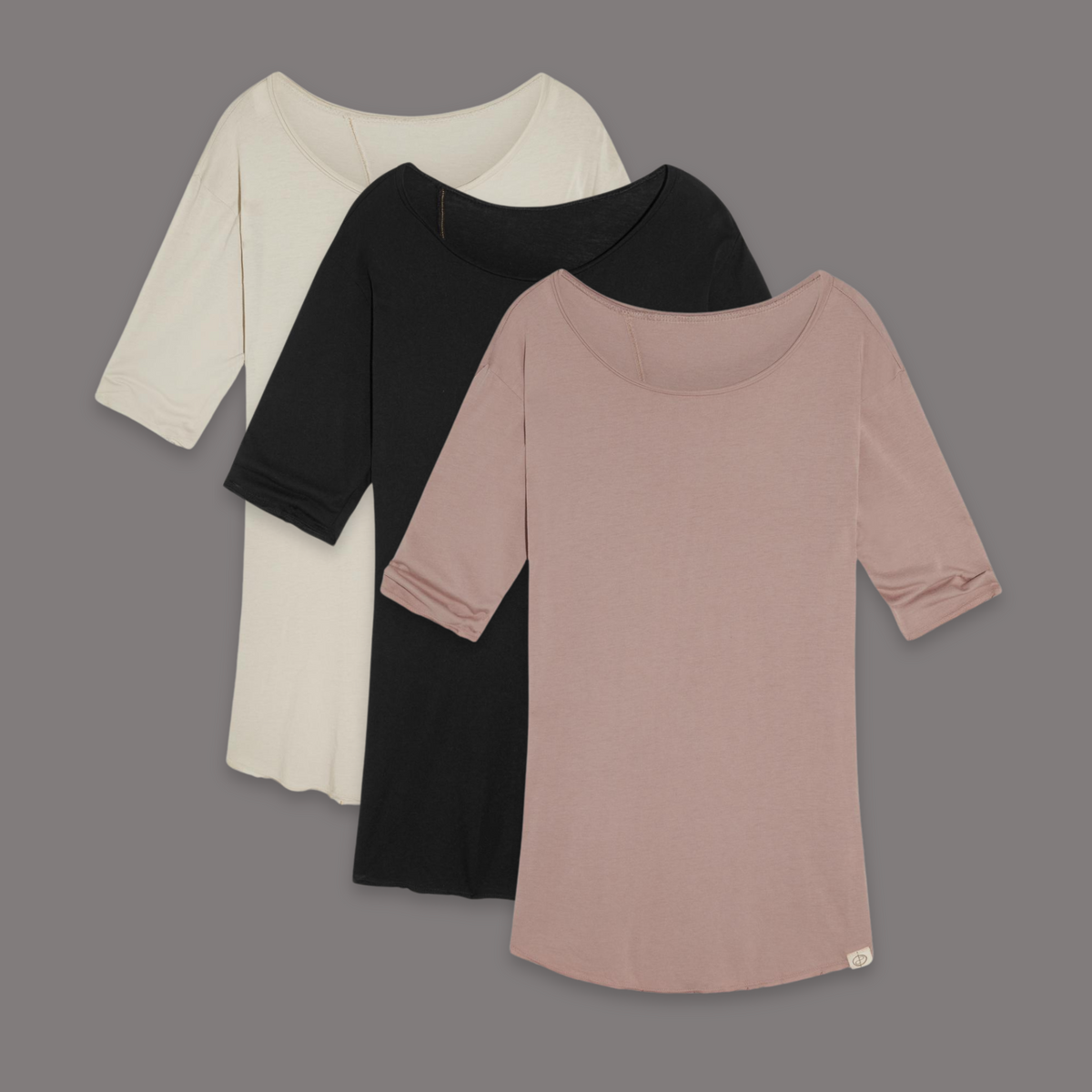 Flat lay of three crew neck shirts in different colors
