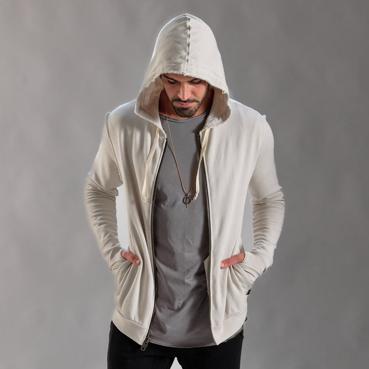 Man modeling a white stone hoodie 