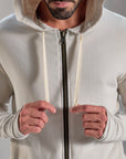 Man modeling a white stone hoodie 