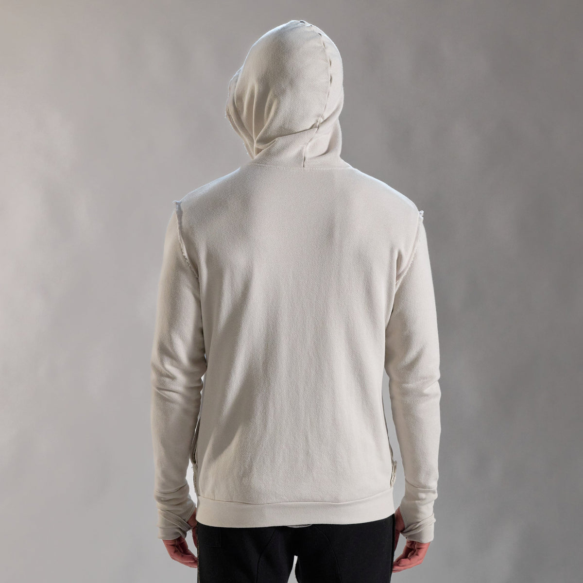 Man modeling a white stone hoodie 