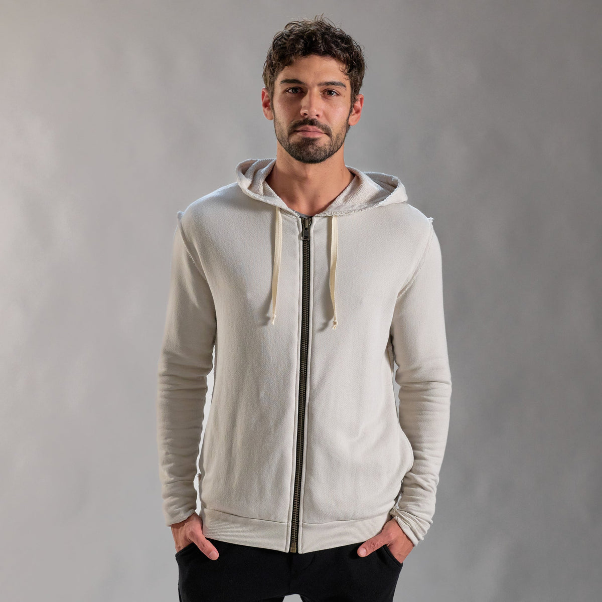 Man modeling a white stone hoodie 