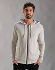 Man modeling a white stone hoodie 