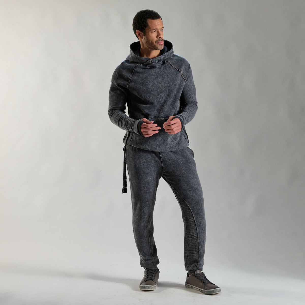 A man modeling dark mineral jogger pants