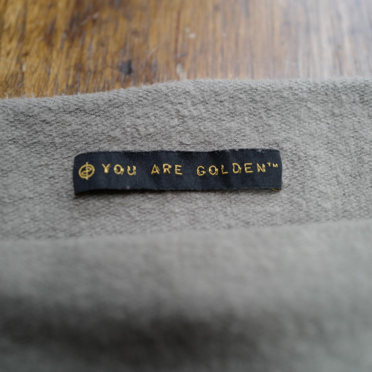 The One Golden Thread OG Cloud Beanie in Shroom with the saying "You are golden"