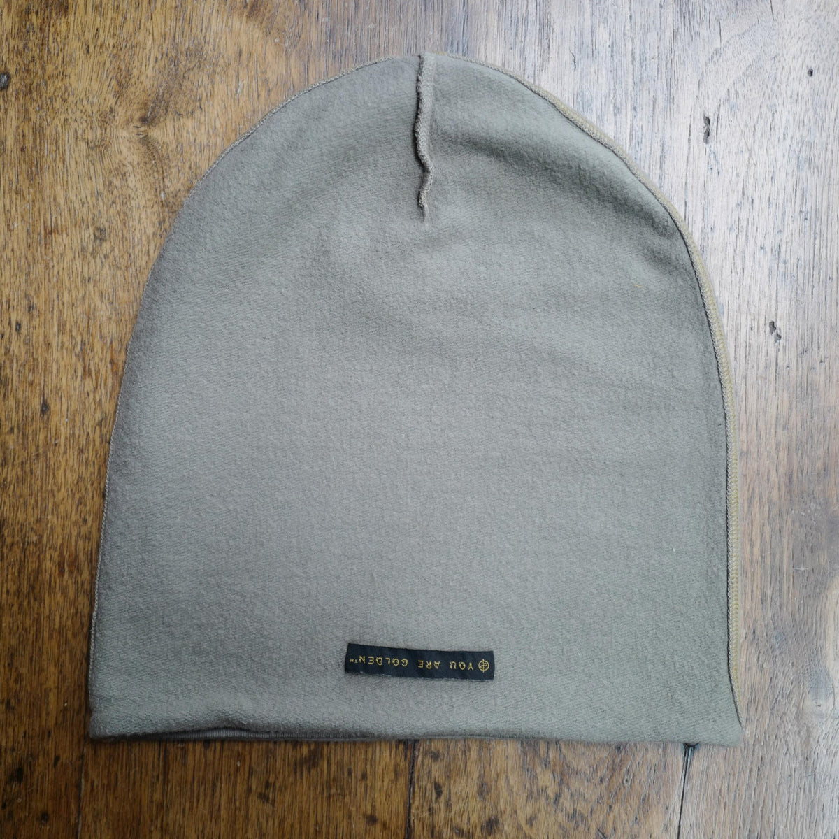 The One Golden Thread OG Cloud Beanie in Shroom with the saying "You are golden"