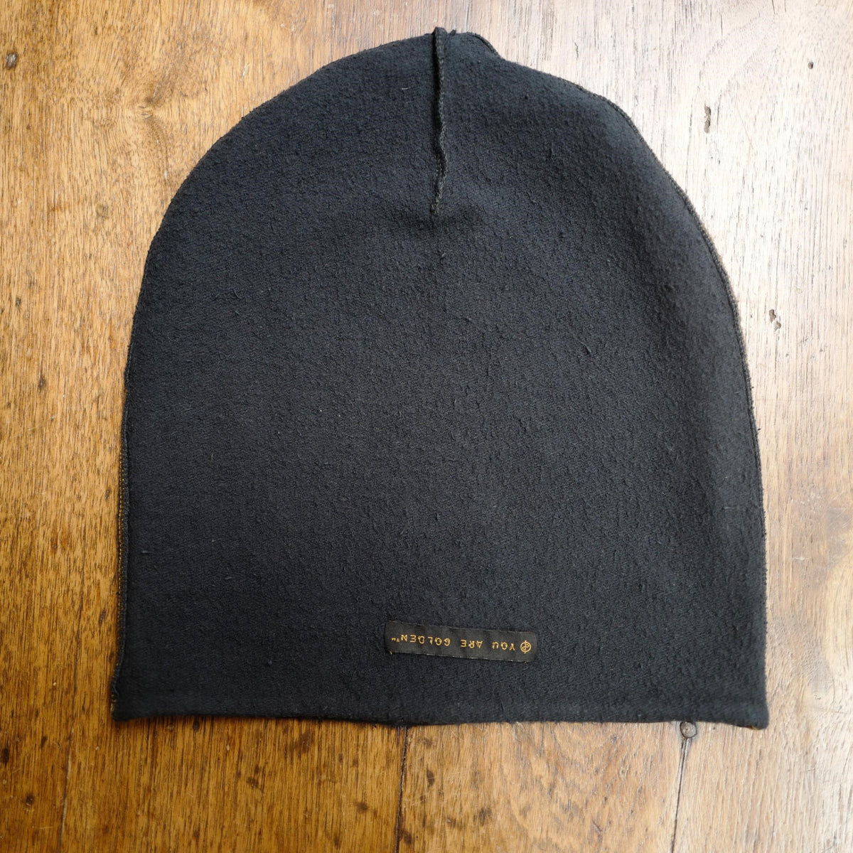The One Golden Thread OG Cloud Beanie in Slate with the saying "You are golden"