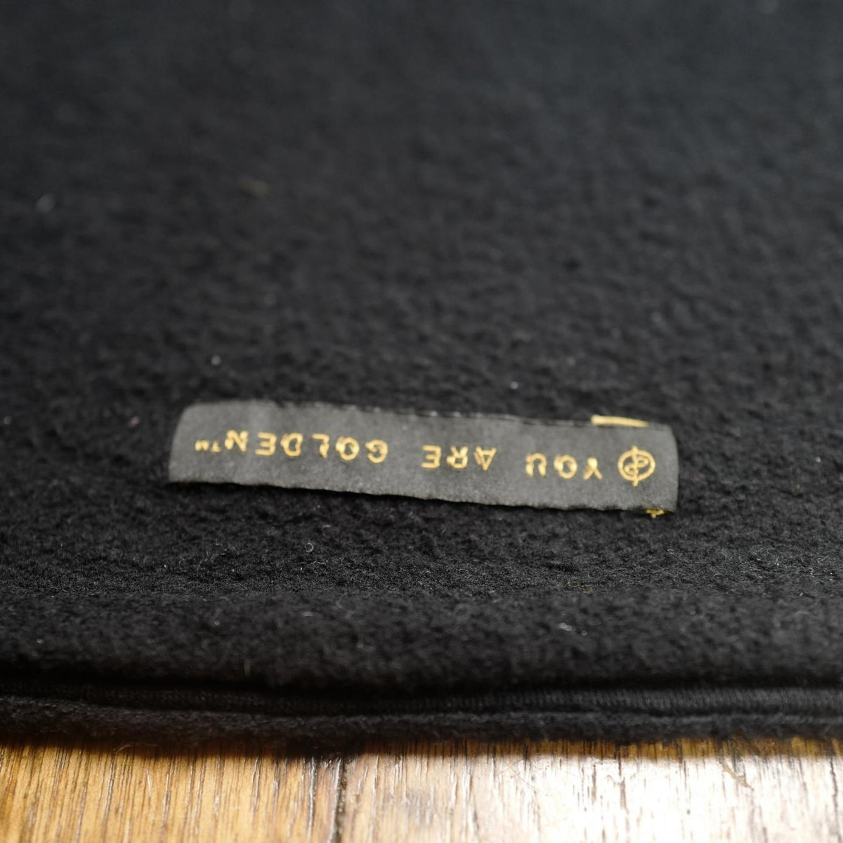 The One Golden Thread OG Cloud Beanie in Black with the saying "You are golden"