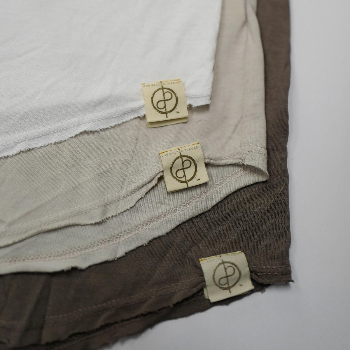 Flat lay of three crew neck shirts in different colors