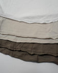 Flat lay of three crew neck shirts in different colors