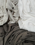 Flat lay of three crew neck shirts in different colors
