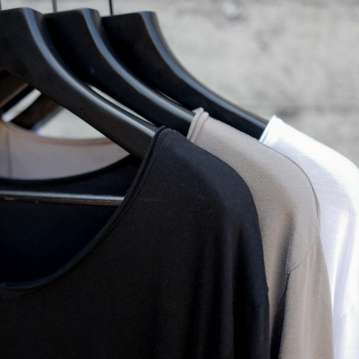 Different colored v neck three pack on clothing racks