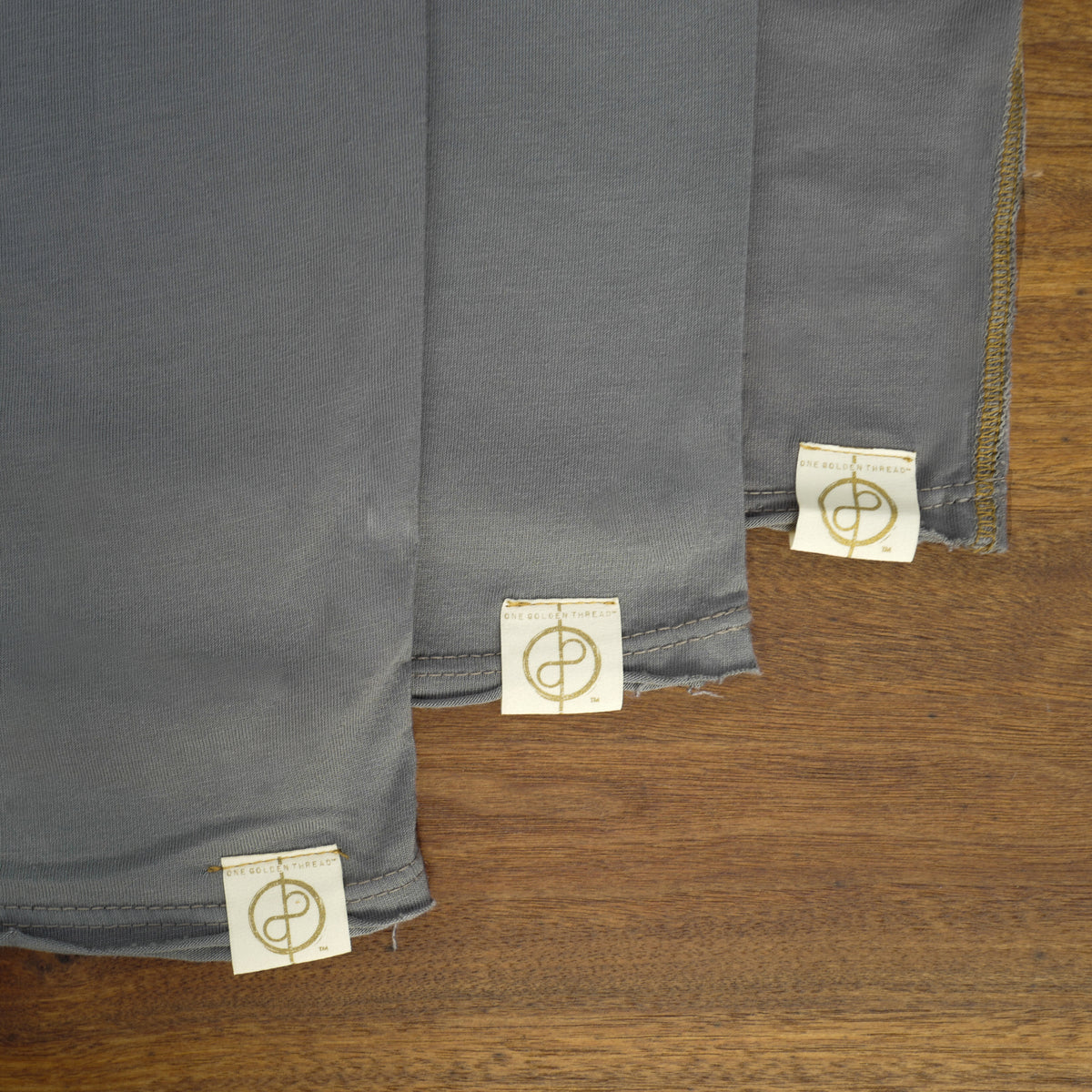Flat lay of ultimate tee three pack in deep clay