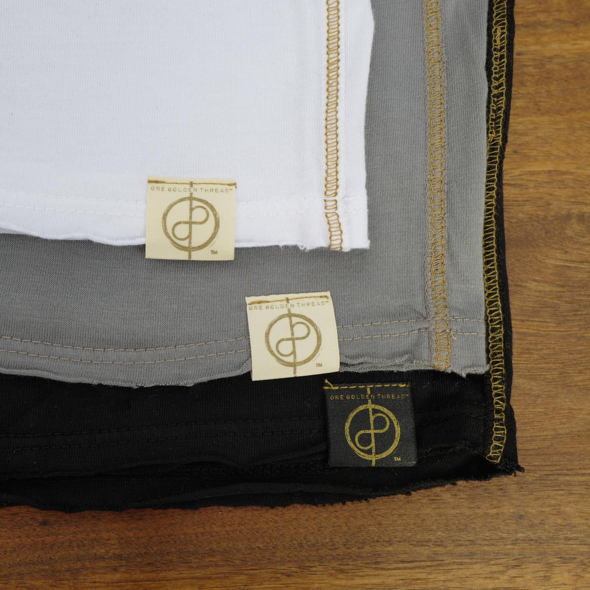 Flat lay of ultimate tee three pack in different colors