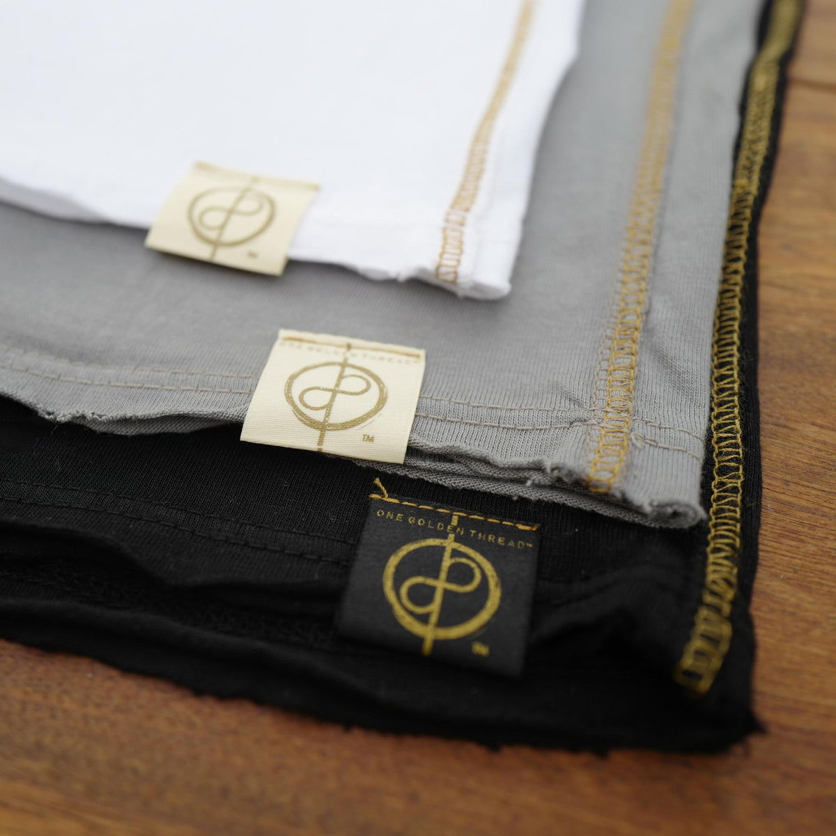 Flat lay of ultimate tee three pack in different colors