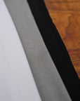 Flat lay of ultimate tee three pack in different colors