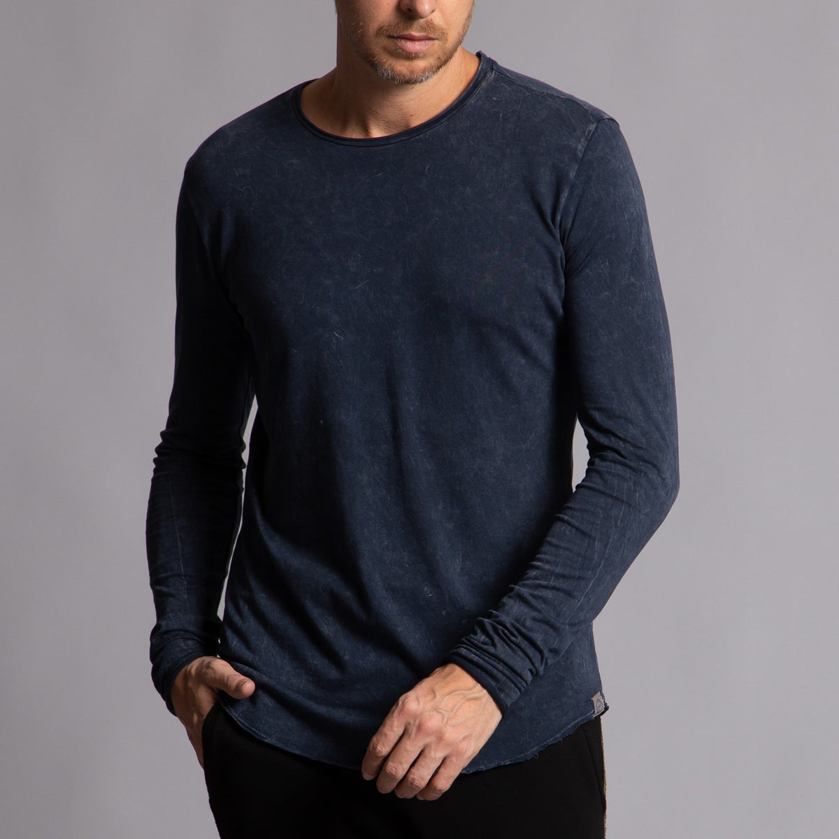 Man modeling a long sleeve crew shirt in charcoal blue