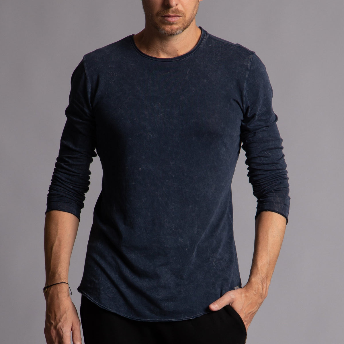 Man modeling a long sleeve crew shirt in charcoal blue