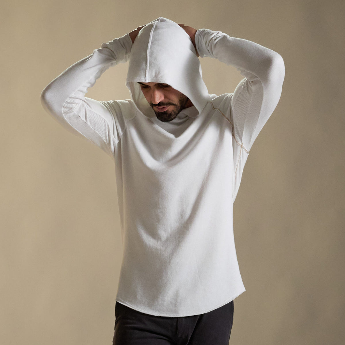 Man modeling white long-sleeve hooded tee
