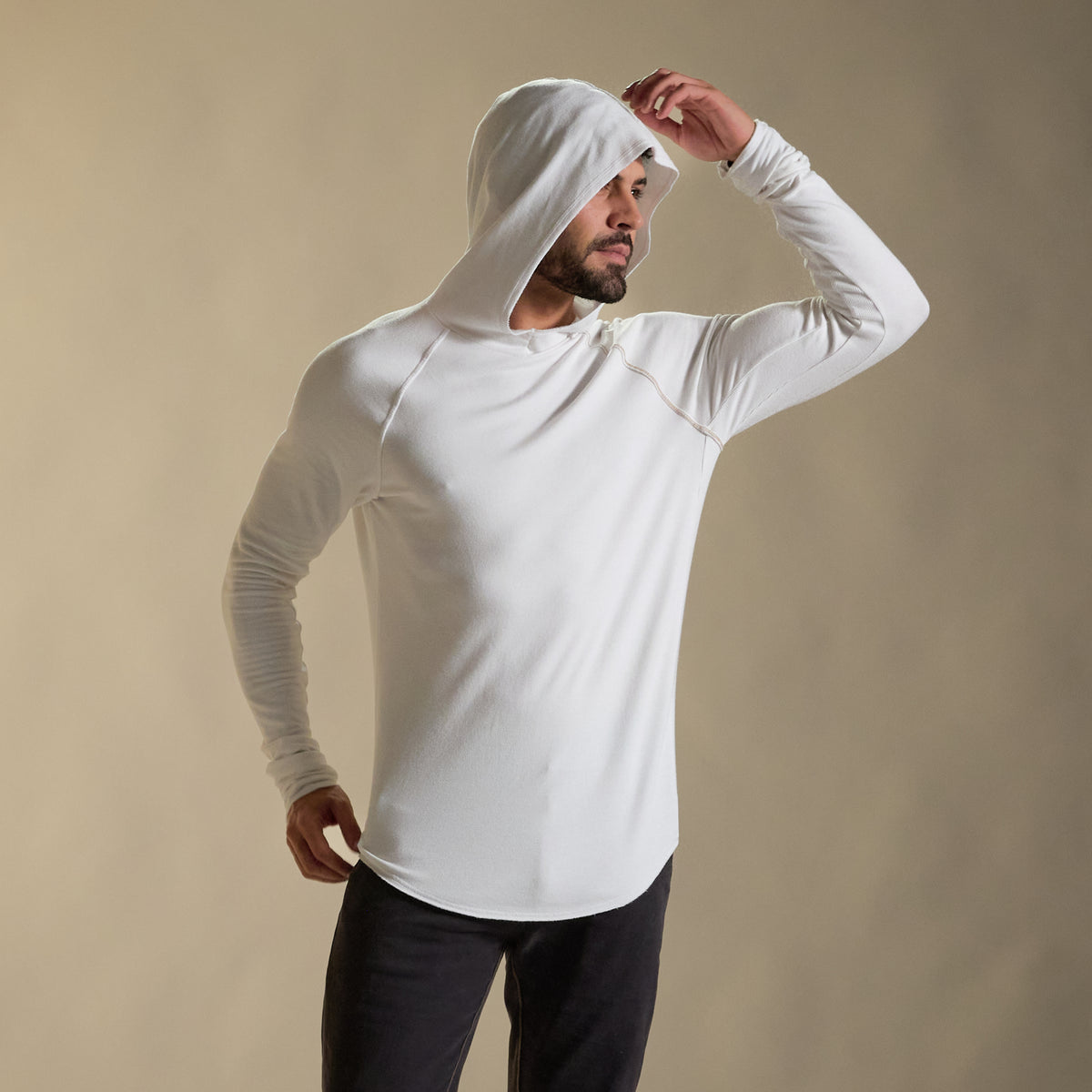Man modeling white long-sleeve hooded tee