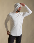 Man modeling white long-sleeve hooded tee