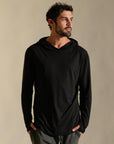 Man modeling black long-sleeve hooded tee