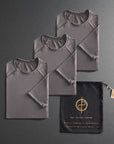 three folded gray shirts on a dark gray background