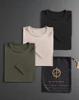 three folded shirts in different colors on a dark gray background