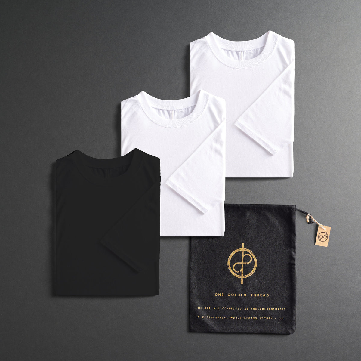three folded shirts in different colors on a dark gray background