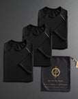 three folded black shirts on a dark gray background