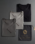 three folded shirts in different colors on a dark gray background
