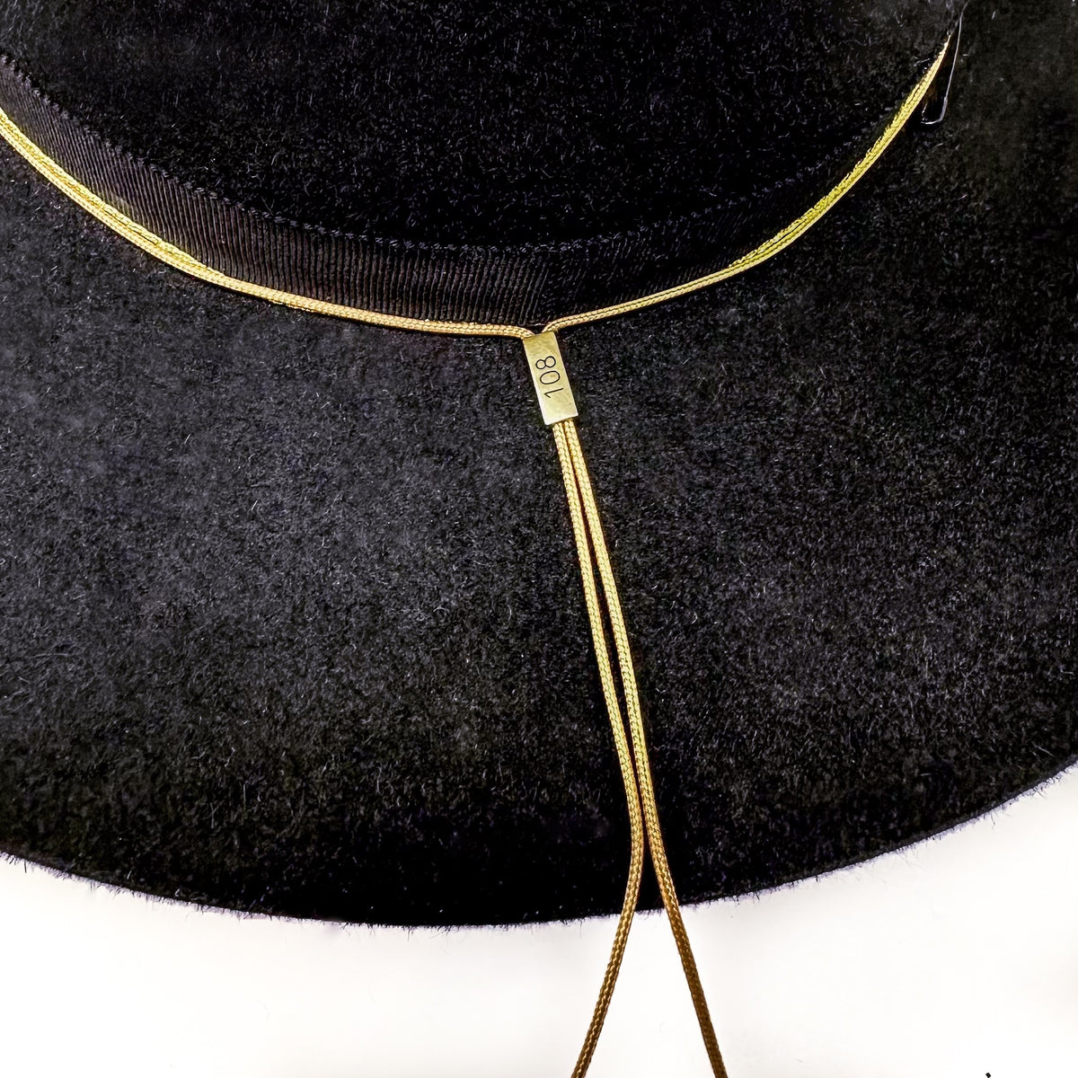 Closeup of OGT Bespoke Hat with 108 Talisman