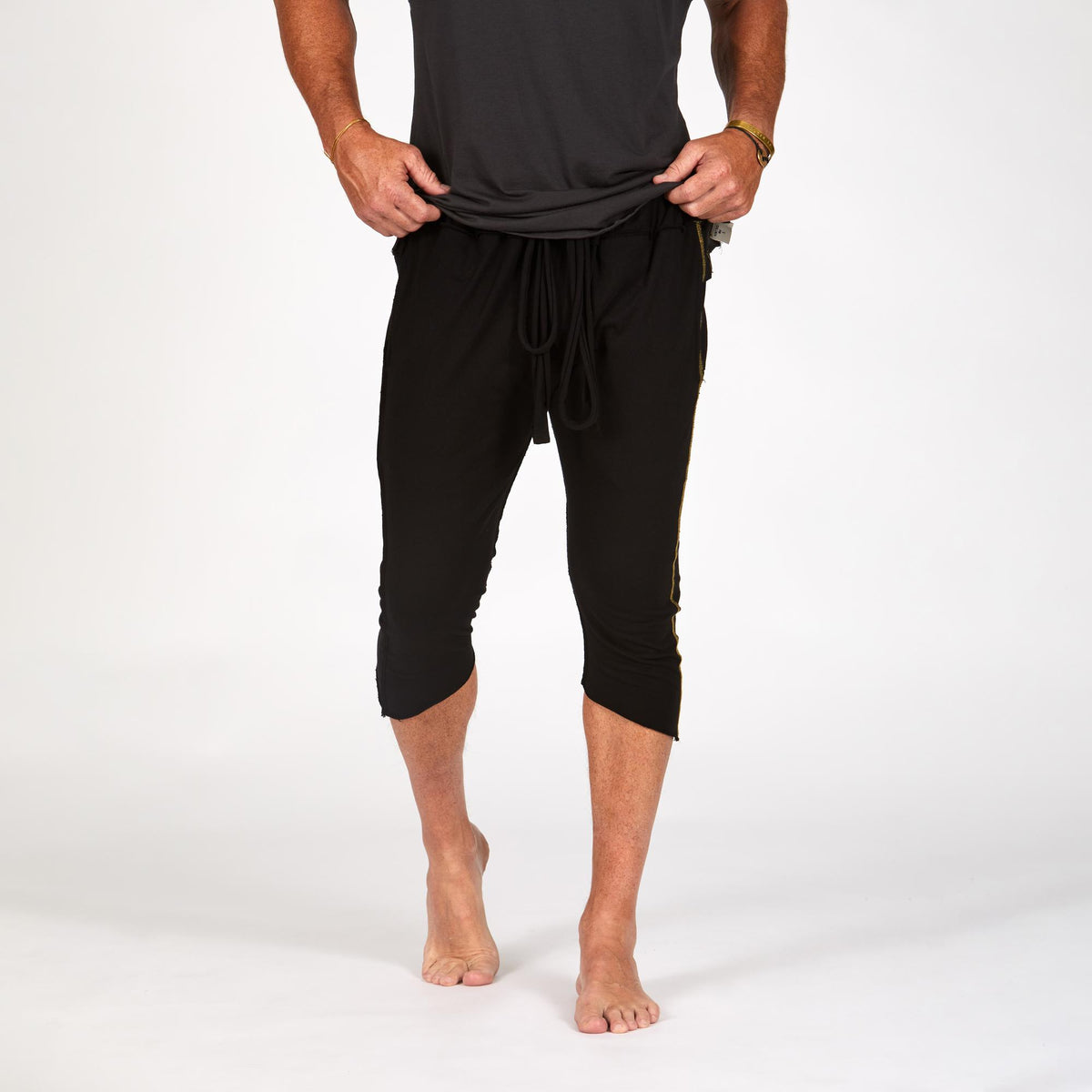 Male modeling black yogo mid shorts