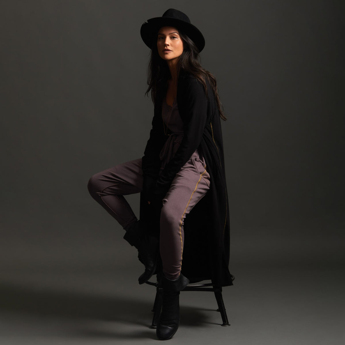 Woman modeling black aion duster