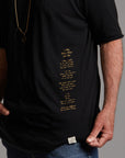 Man modeling a crew neck t shirt with gold graphics