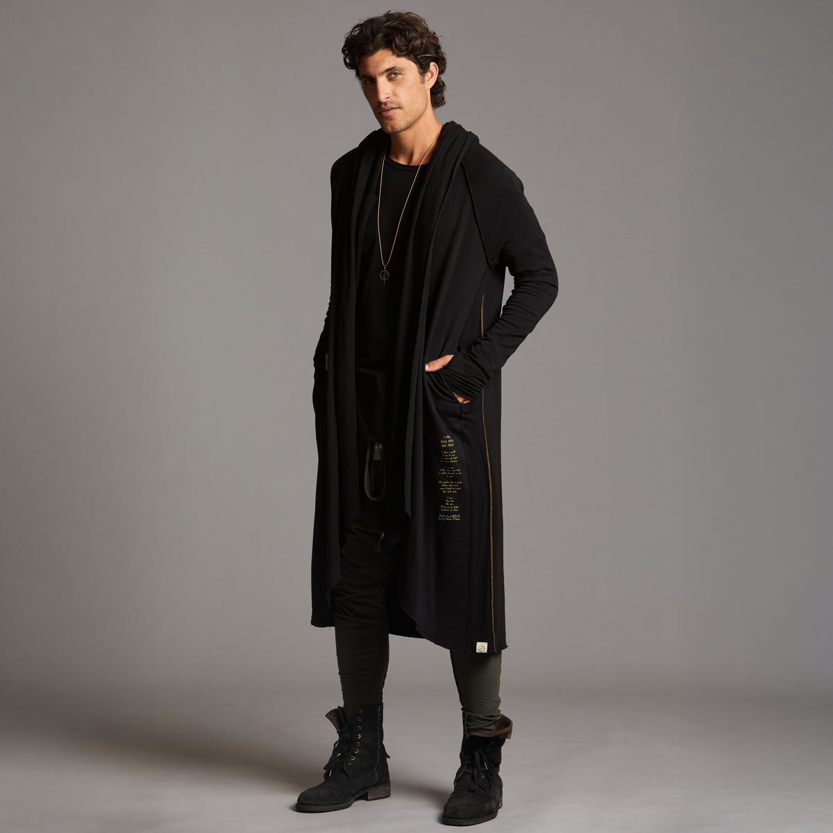 Man modeling a duster with gold graphics