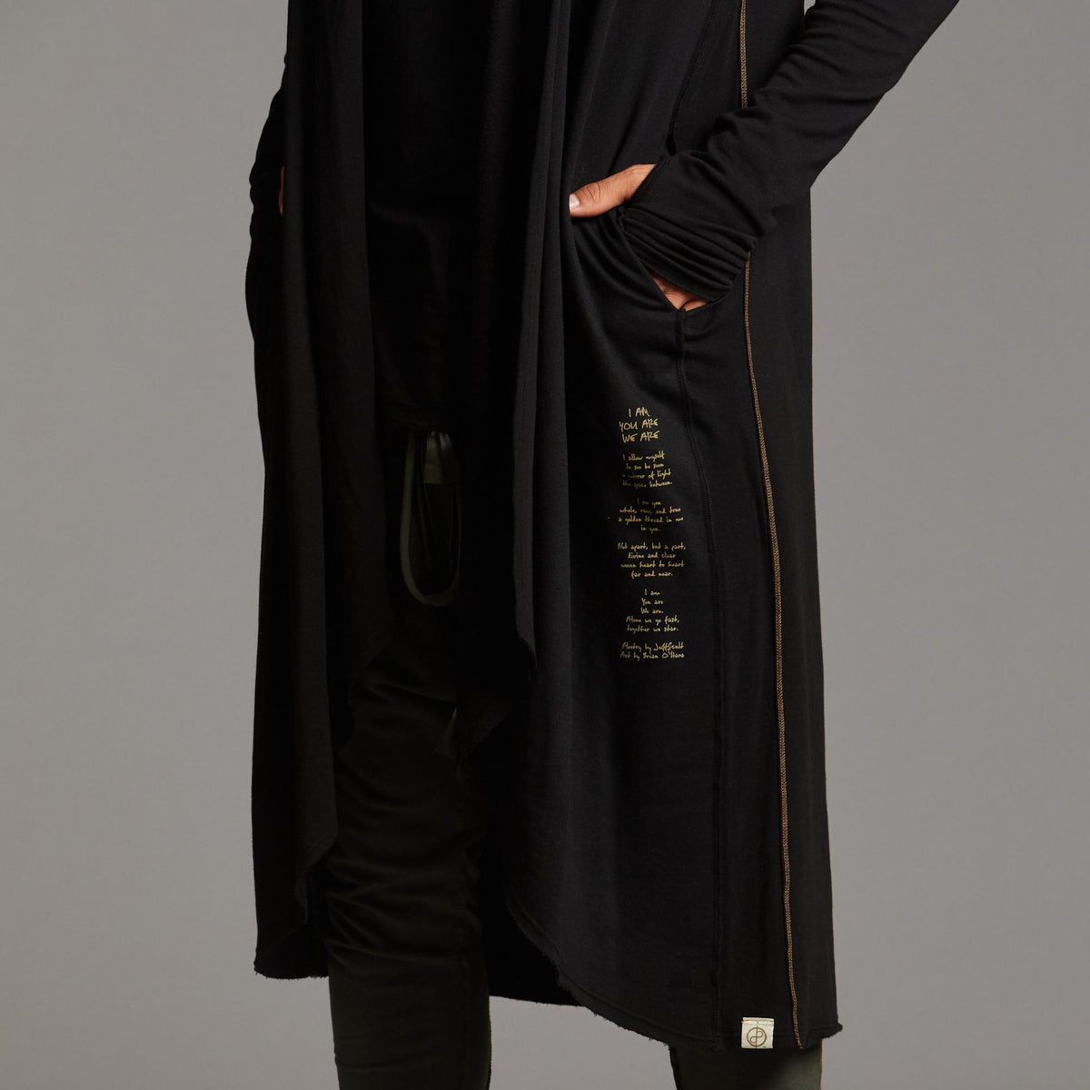 Man modeling a duster with gold graphics