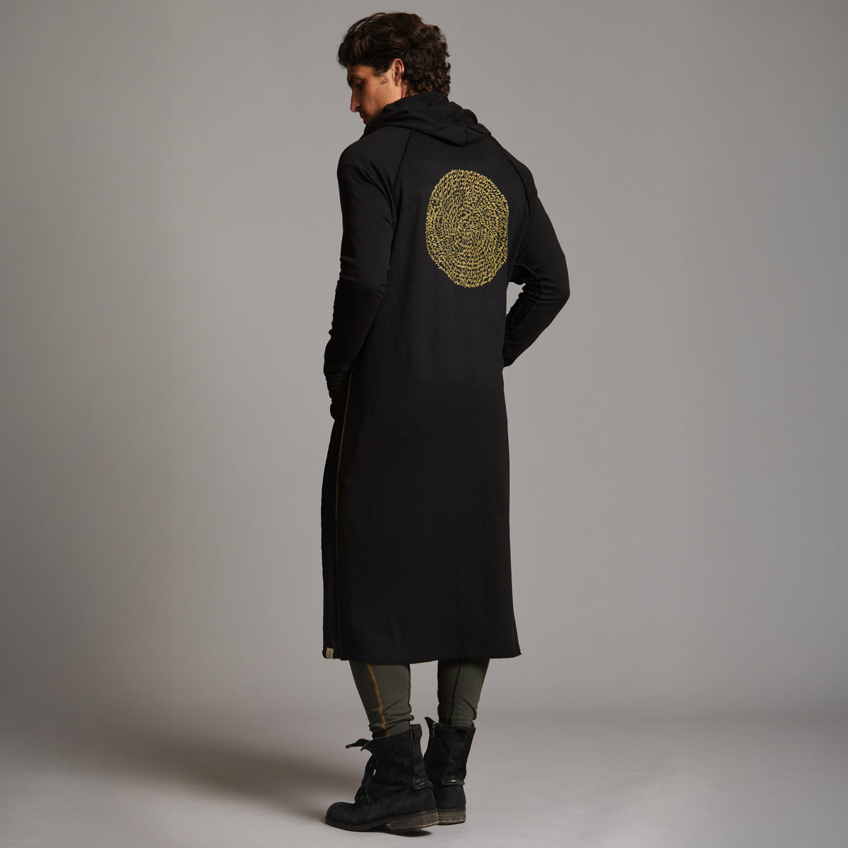 Man modeling a duster with gold graphics