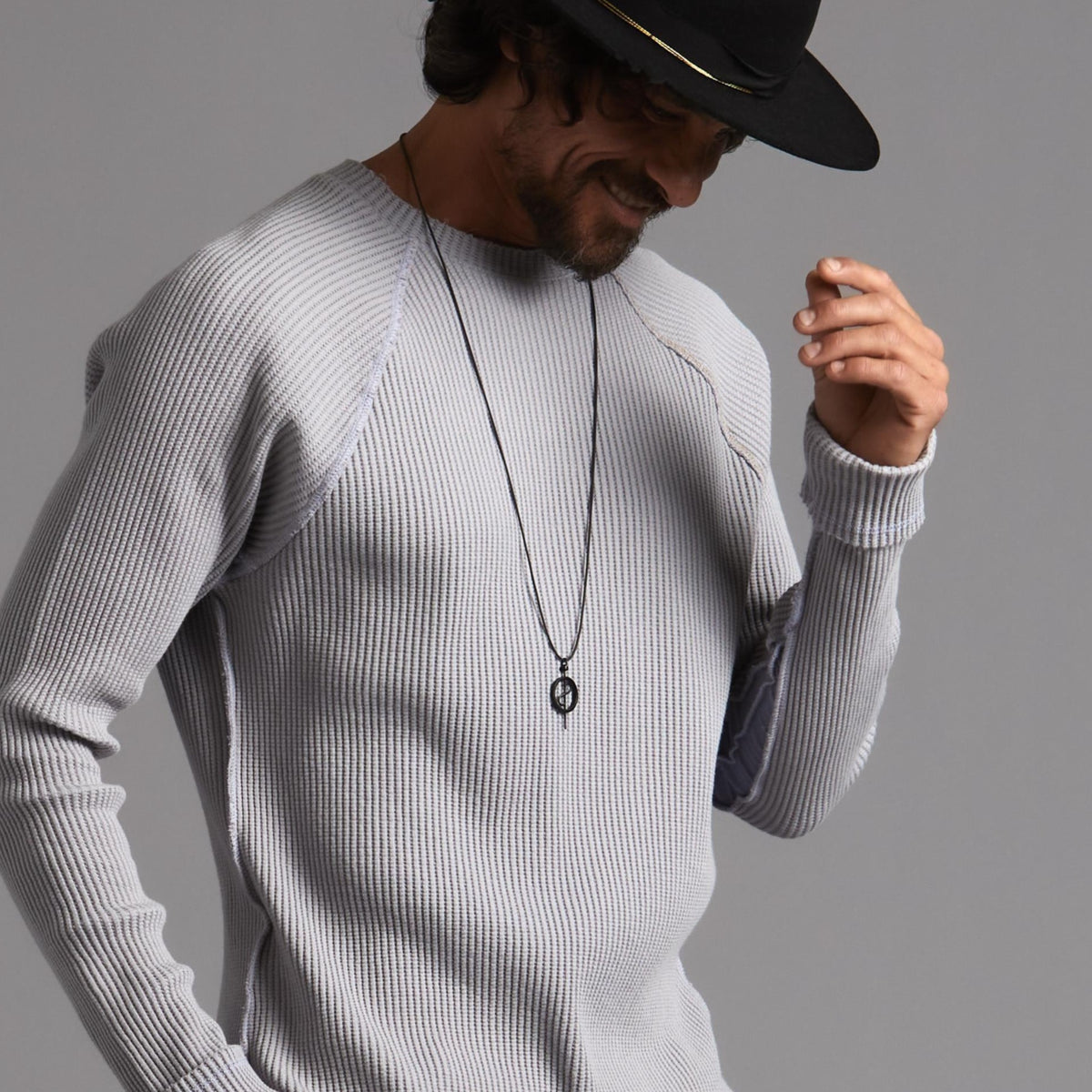 A model wearing the 108 Talisman Necklace in Ceramic Black