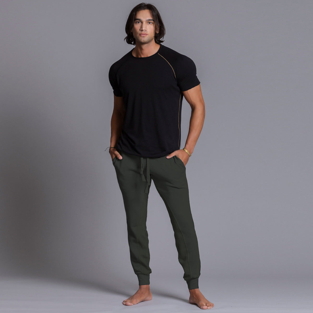 A man modeling Urban Forest green colored jogger pants