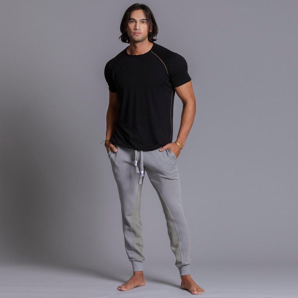 A man modeling Deep Clay gray colored jogger pants