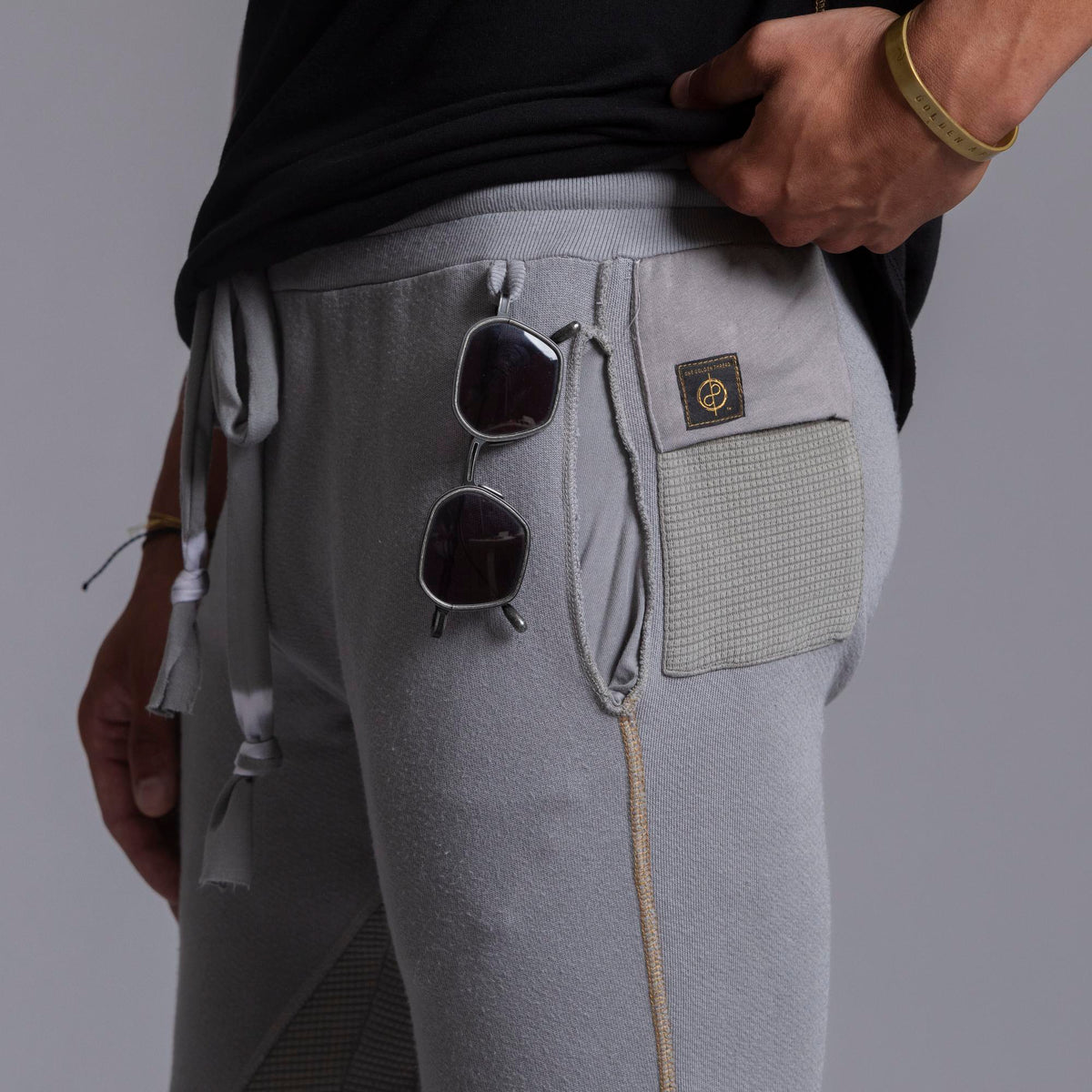 A man modeling Deep Clay gray colored jogger pants