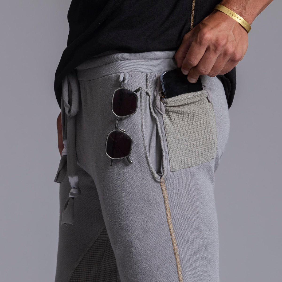A man modeling Deep Clay gray colored jogger pants