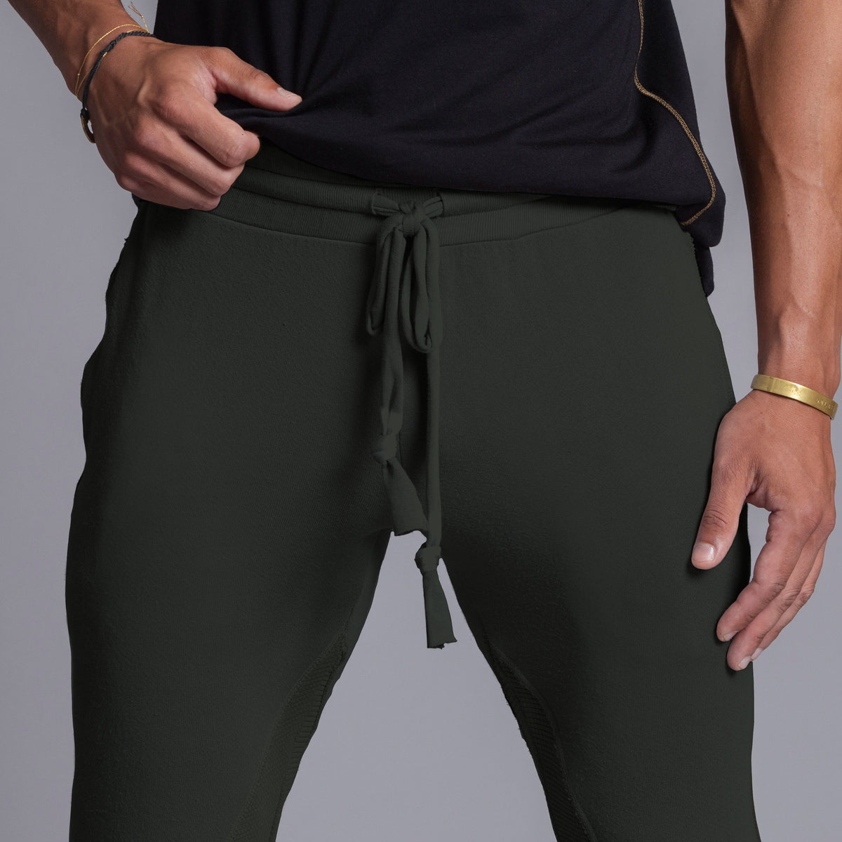 A man modeling Urban Forest green colored jogger pants