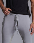 A man modeling Deep Clay gray colored jogger pants