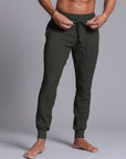A man modeling Urban Forest green colored jogger pants