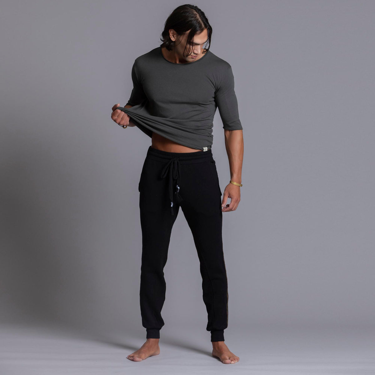 A man modeling black colored jogger pants